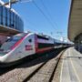 A high-speed TGV Lyria train speeds through snowy Swiss Alps