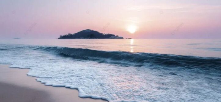 A vibrant sunset over Crescent Bay with soft waves lapping at white sand