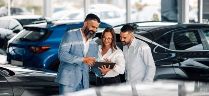 Auto dealership showroom with shiny cars and smiling staff