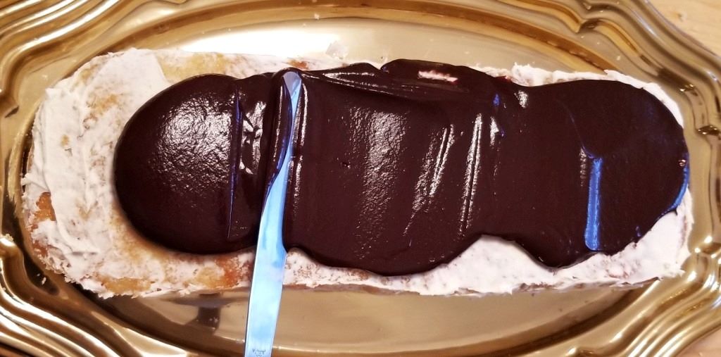 Cross-section view of layered gansito cake showing cream filling and chocolate sponge cake
