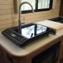 Compact single burner induction cooktop on RV counter