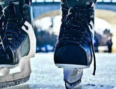 Skater gliding on freshly sharpened ice skate blades, demonstrating improved speed, balance, and control on an indoor rink in California