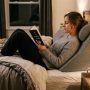 White foam bed positioning wedge pillow sitting on a modern minimalist bed.