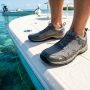 Angler wearing breathable mesh fishing shoes on a boat deck in Florida.