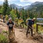 Volunteers clearing trails and removing invasive plants at a national park during National Public Lands Day on September 26, 2026