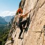Climber ascending a rock wall using a reliable dynamic climbing rope outdoors.