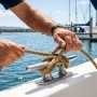 Coiled blue marine anchor rope on a boat deck