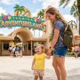 Parent wearing a diaper backpack during a sunny Florida outdoor outing.