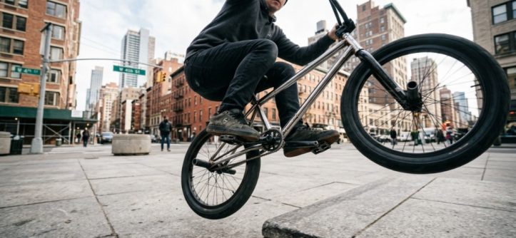 Close-up of durable metal BMX pedals on a street bike in New York.